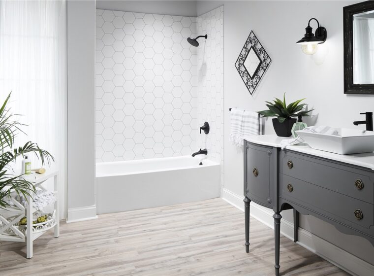 Black and white modern bathroom with hardwood floor and raised fixtures