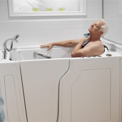 Elderly man bathing in walk-in tub