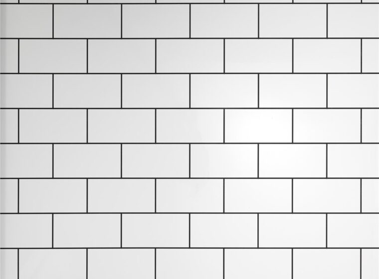 White rectangular shower tiles in a simple repeating pattern