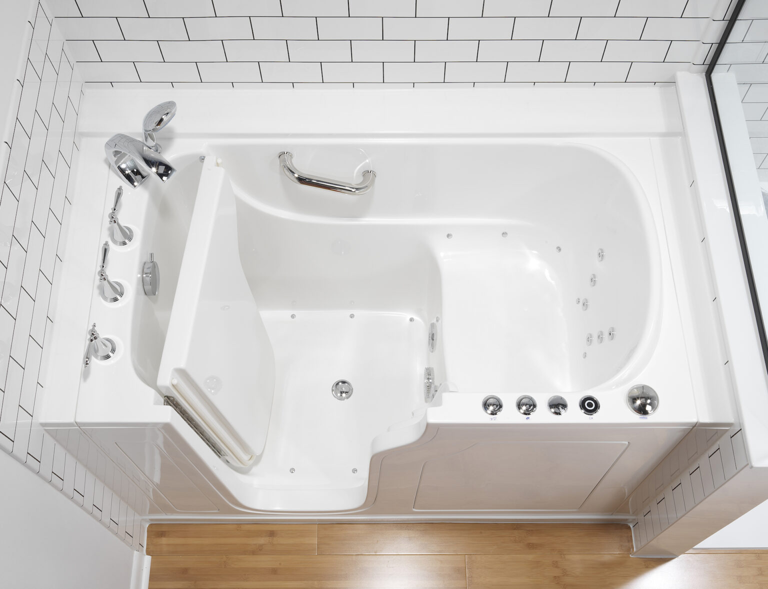 Walk-in tub features include bench for sitting, multiple holding bars and easy-to-use controls