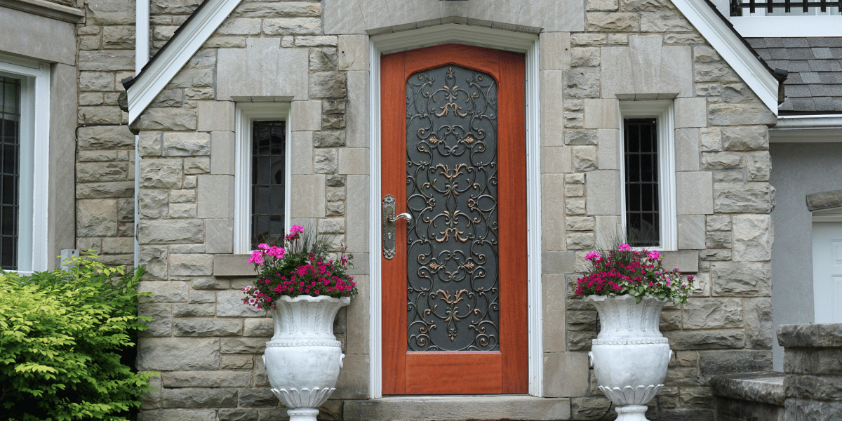 Replacing Your Doors_ Here Are Five Front Door Styles You'll Love Coming Home To - exterior door with decoration on a stone-front house
