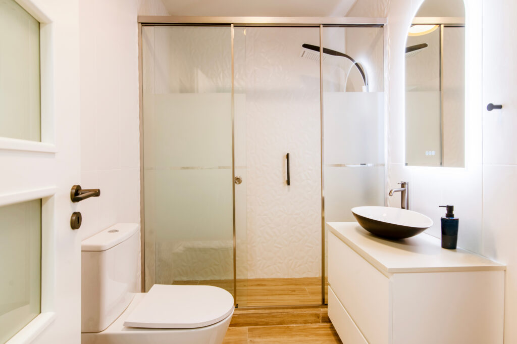 walk-in shower vs. tub-to-shower conversion - small bathroom with shower sink and tub