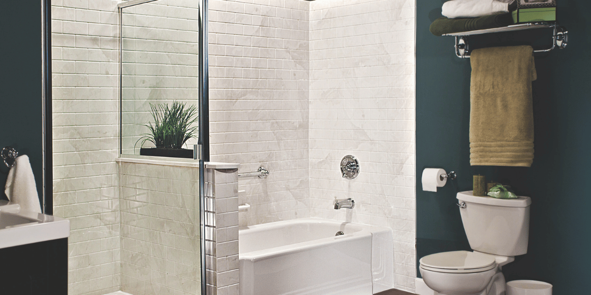 five reasons to hire a pro contractor for your bathroom remodel - green bathroom with white subway tile bathtub and shower
