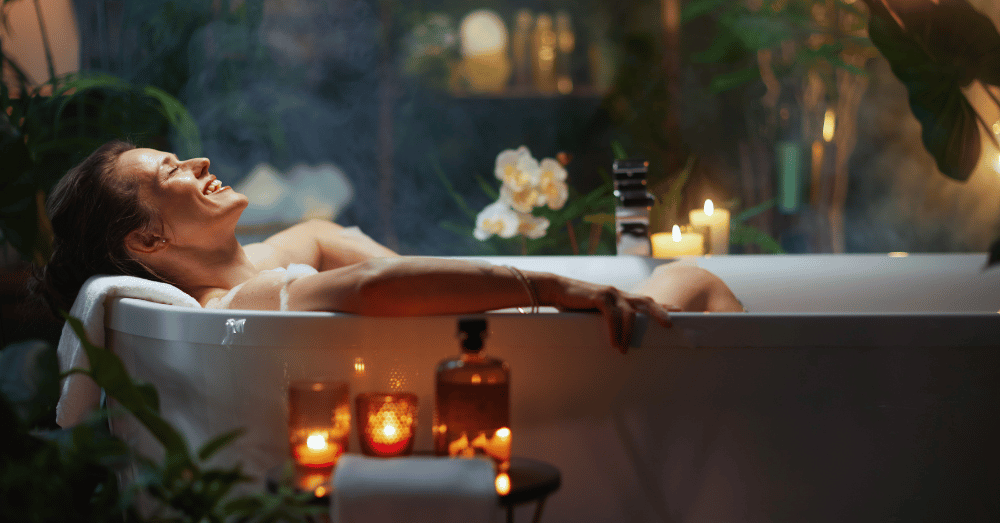 5 Luxury Bathroom Features Trending in Bowling Green - smiling woman in candlelit bubble bath