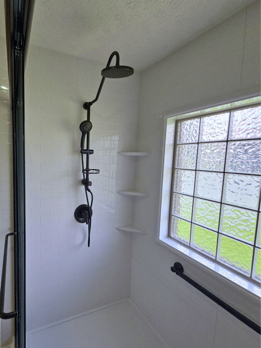 Budgeting Your Bathroom Remodel Near Bowling Green KY - white tile shower with black fixtures