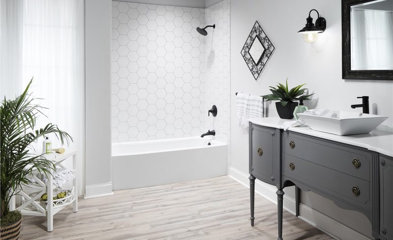 Black and white modern bathroom with hardwood floor and raised fixtures