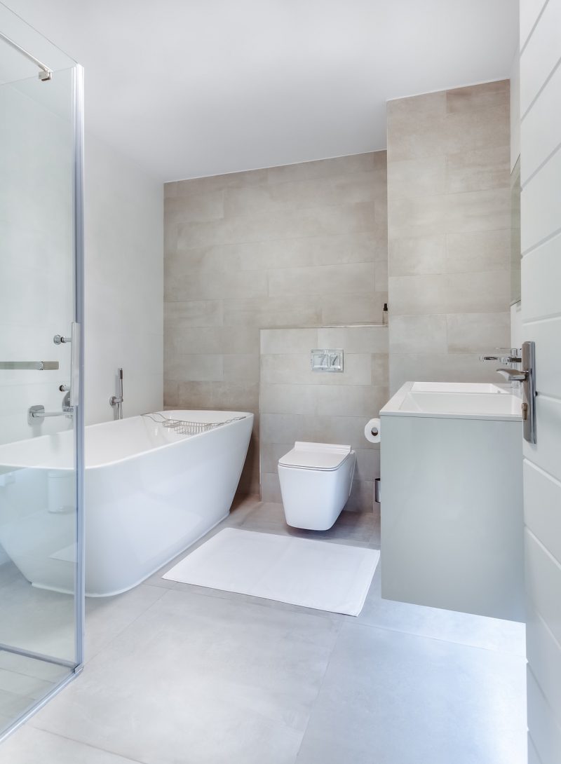 All-white modern bathroom with contour tub